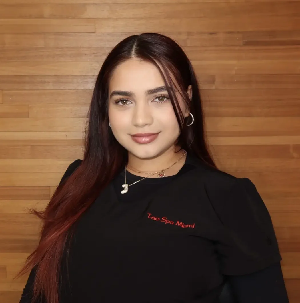 A woman with long hair wearing black and red.